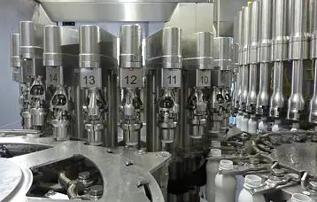 Aseptic capper with hygienic design: all mechanical driving parts are located outside the sterile zone
